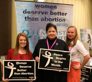 FFL interns Kara Sorenson, from Clarion University, (left) and Madeline Davin from Wheeling Jesuit (right), pose with FFL President Serrin Foster at the FFL booth at the first-ever Pro-Life Women's Conference in Dallas.